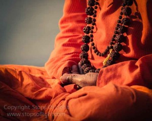 A renuncient meditates on the river ghats, Varanasi
