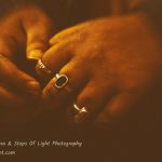 Various rings adorn the fingers of a devotee - Ganga aarti, Varanasi, India